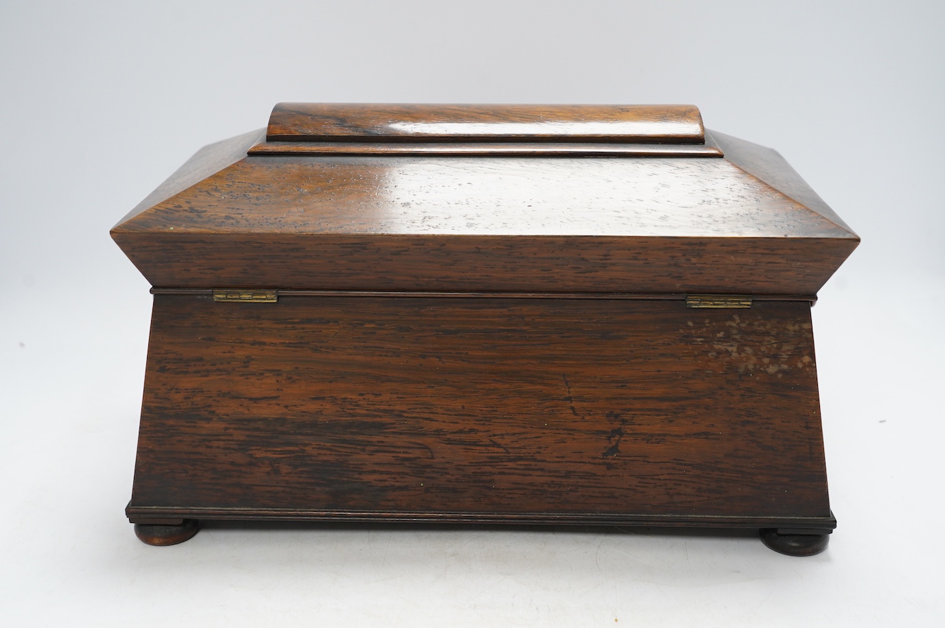 A Victorian rosewood sarcophagus shaped tea caddy with mother of pearl escutcheon, 33.5cm wide. Condition - fair, some internal damage